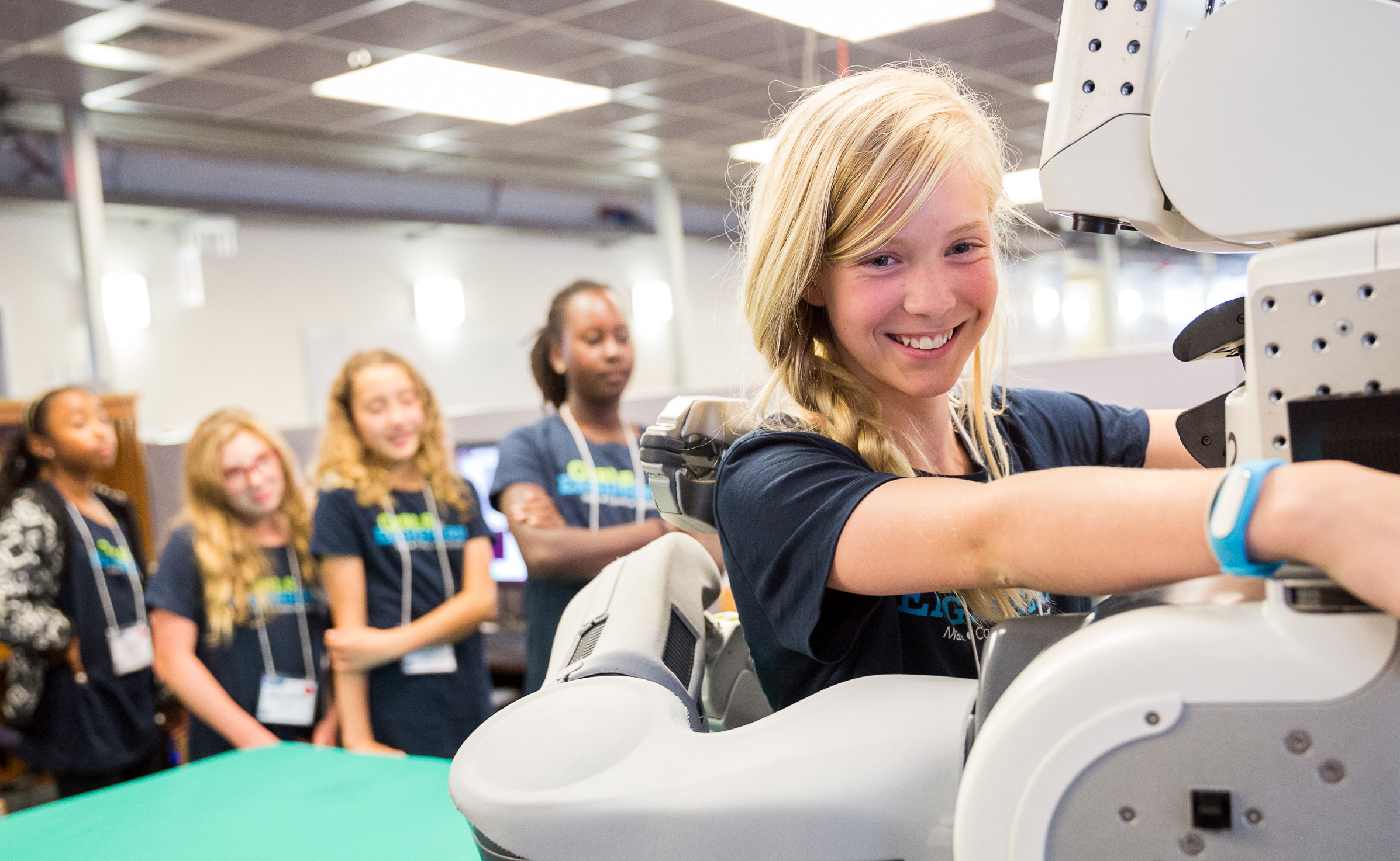 girl smiling while operating a machine